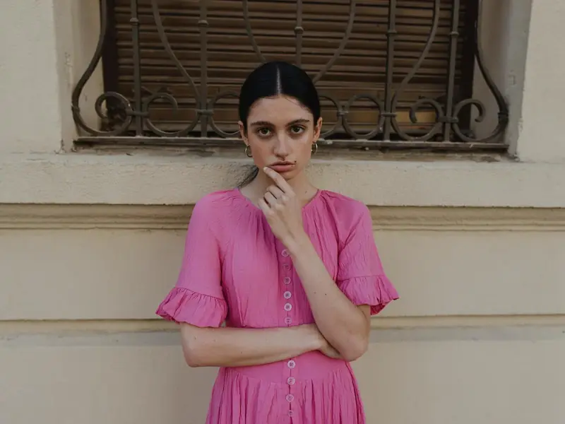 FLUX.3 Klein: A woman in a pink dress against a cream wall